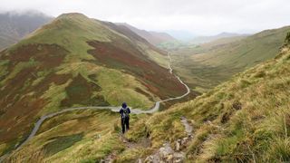 Man on a mountain pass on a rainy day