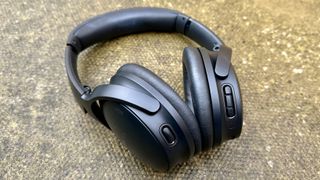 The Bose Quietcomfort over-ear headphones pictured on concrete