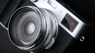 Close-up of lens of Fujifilm X100VI compact camera