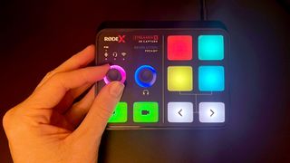 RODE Streamer X switched on and being used by a reviewer, showing the multiple touchpads and lights operating