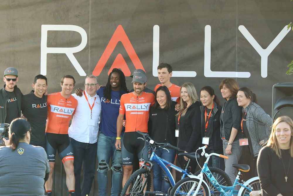 Rally riders pose for a photo with Melvin Gordon and AEG's Kristin Klein