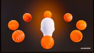 A model head is surrounded by seven orange balls evenly spread out around it