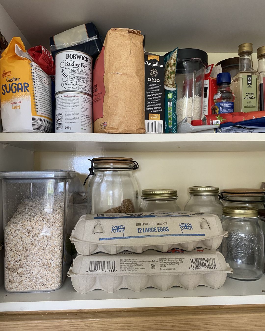 Kitchen cupboard with food items and storage jars