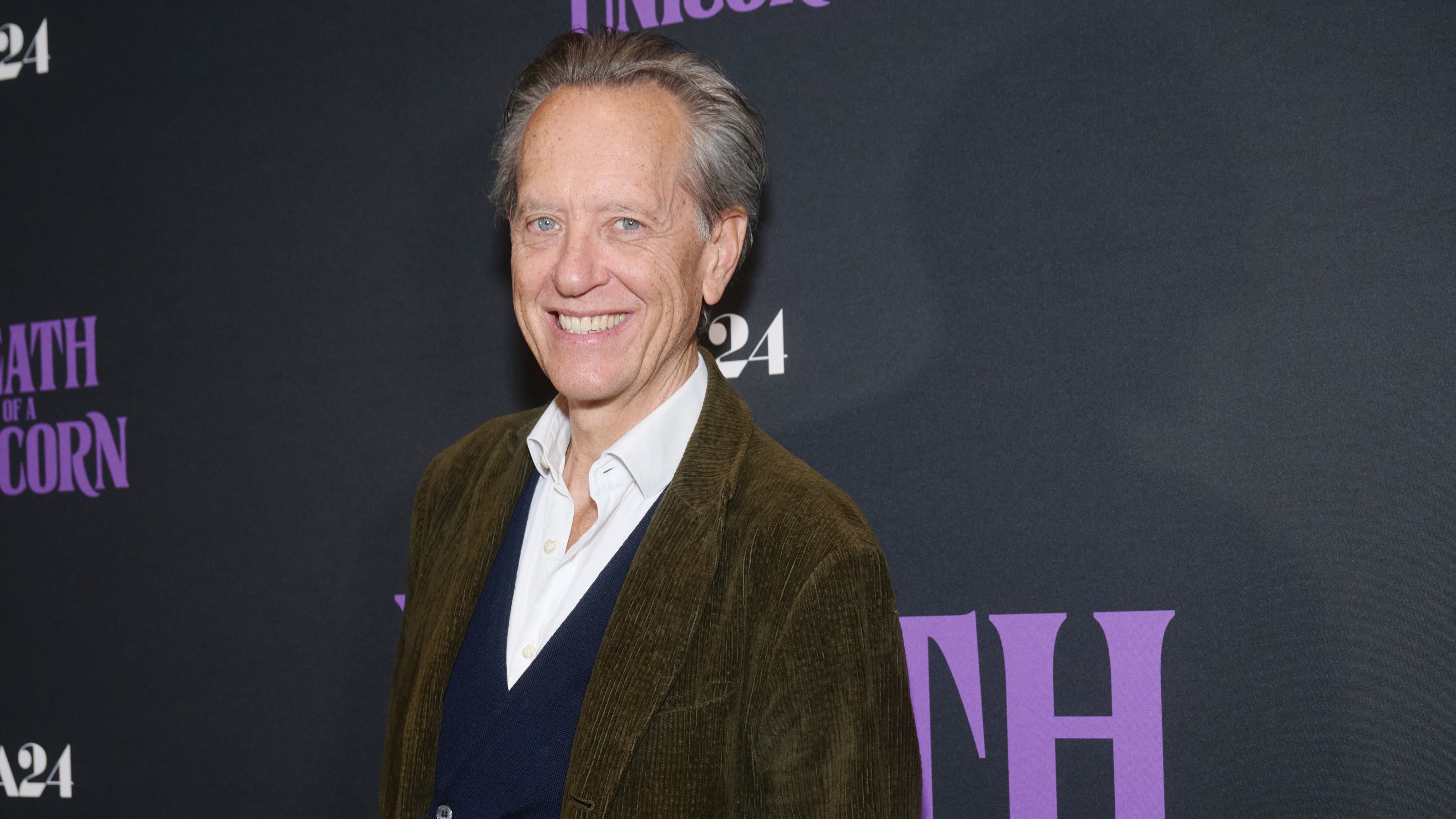 A portrait of actor Richard E. Grant at a movie premiere