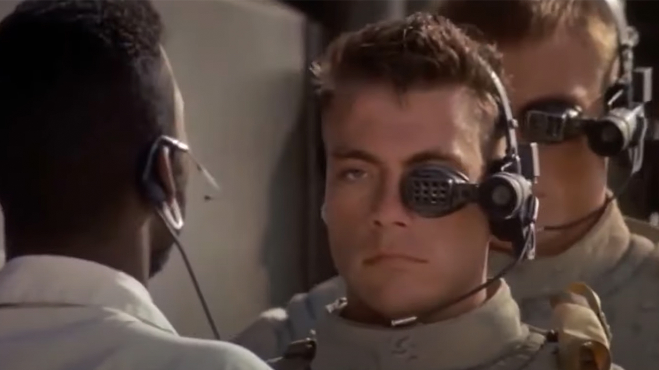 Jean-Claude Van Damme standing in front of Dolph Lundgren in Universal Soldier.