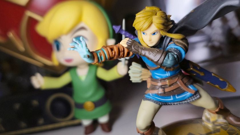 Image of the Tears of the Kingdom Link amiibo sitting in front of a shelf of Zelda merch.