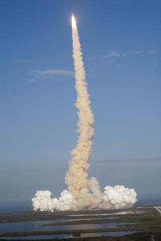 S[ace shuttle Discovery streaks into the sky on its final mission STS-133