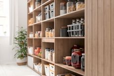 Open kitchen shelving with organized packets and jars of food