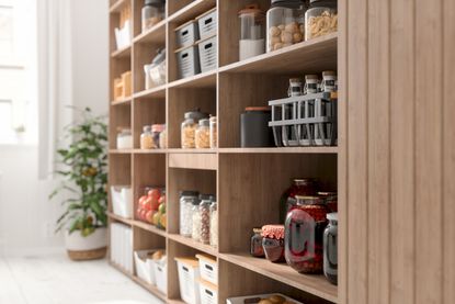 Open kitchen shelving with organized packets and jars of food