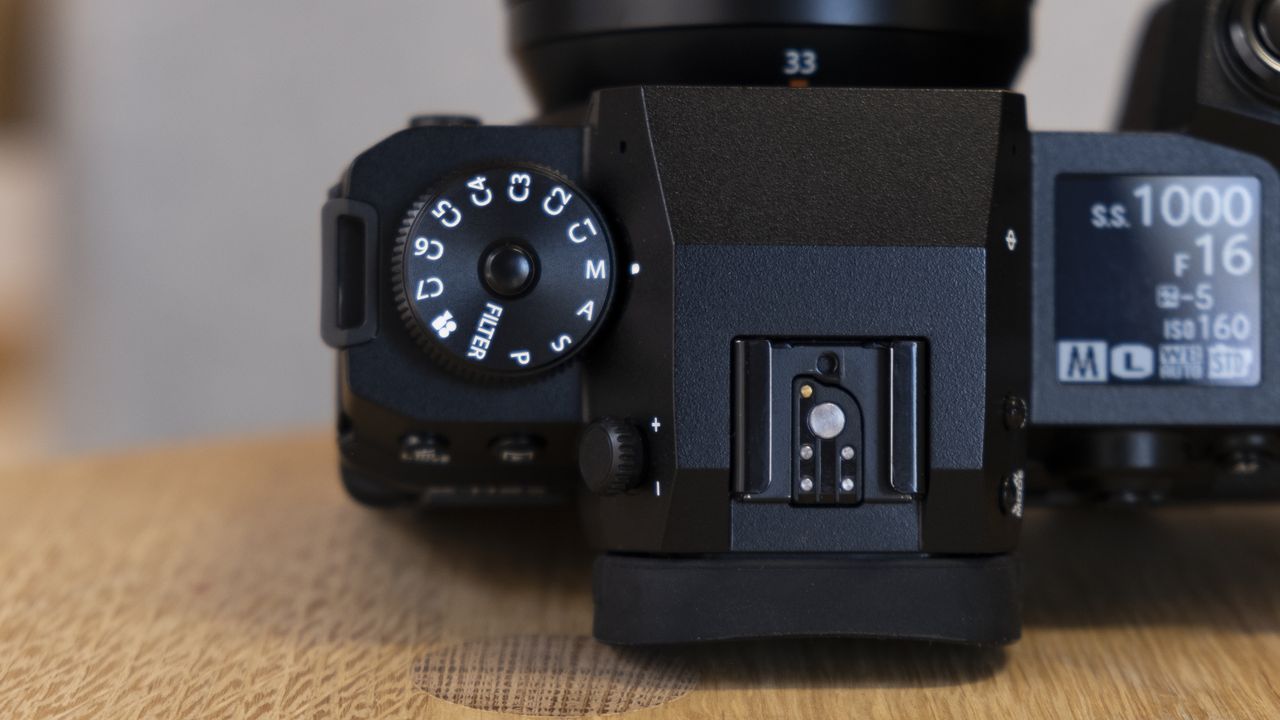 The Fujifilm X-H2S camera on a wooden table