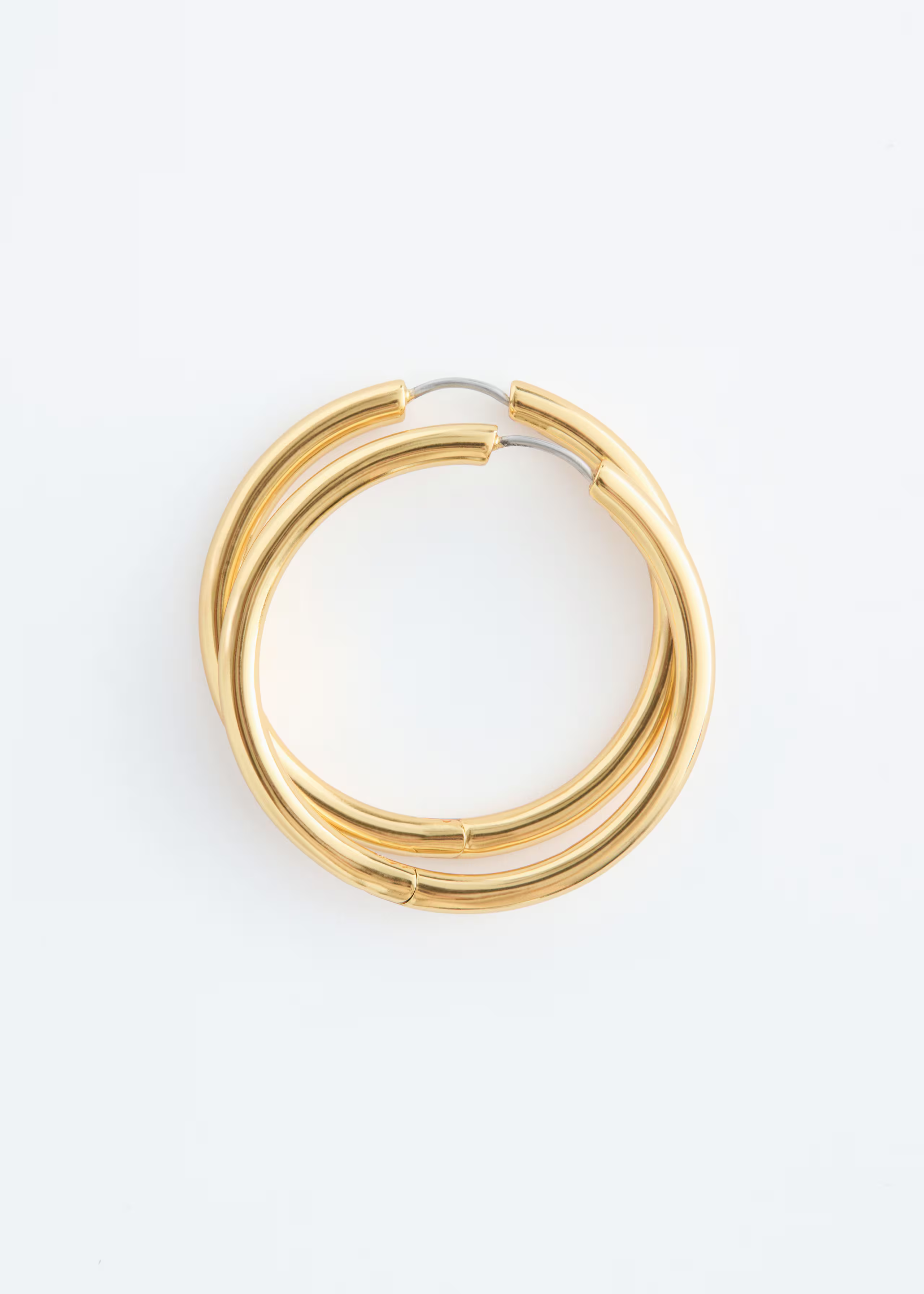 A pair of &amp;amp; other Stories gold hoop earrings.