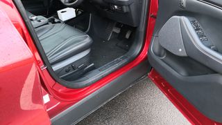 red ford mustang mach-e with door open revealing battery in floorpan