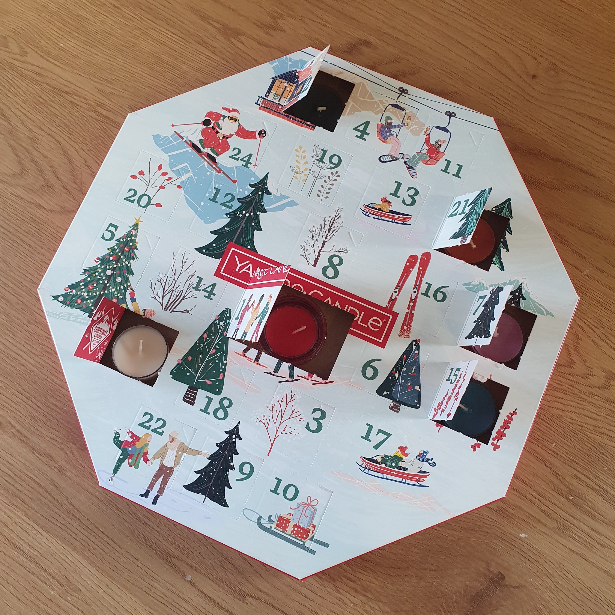 The Yankee Candle Wreath Advent Calendar with a few open windows