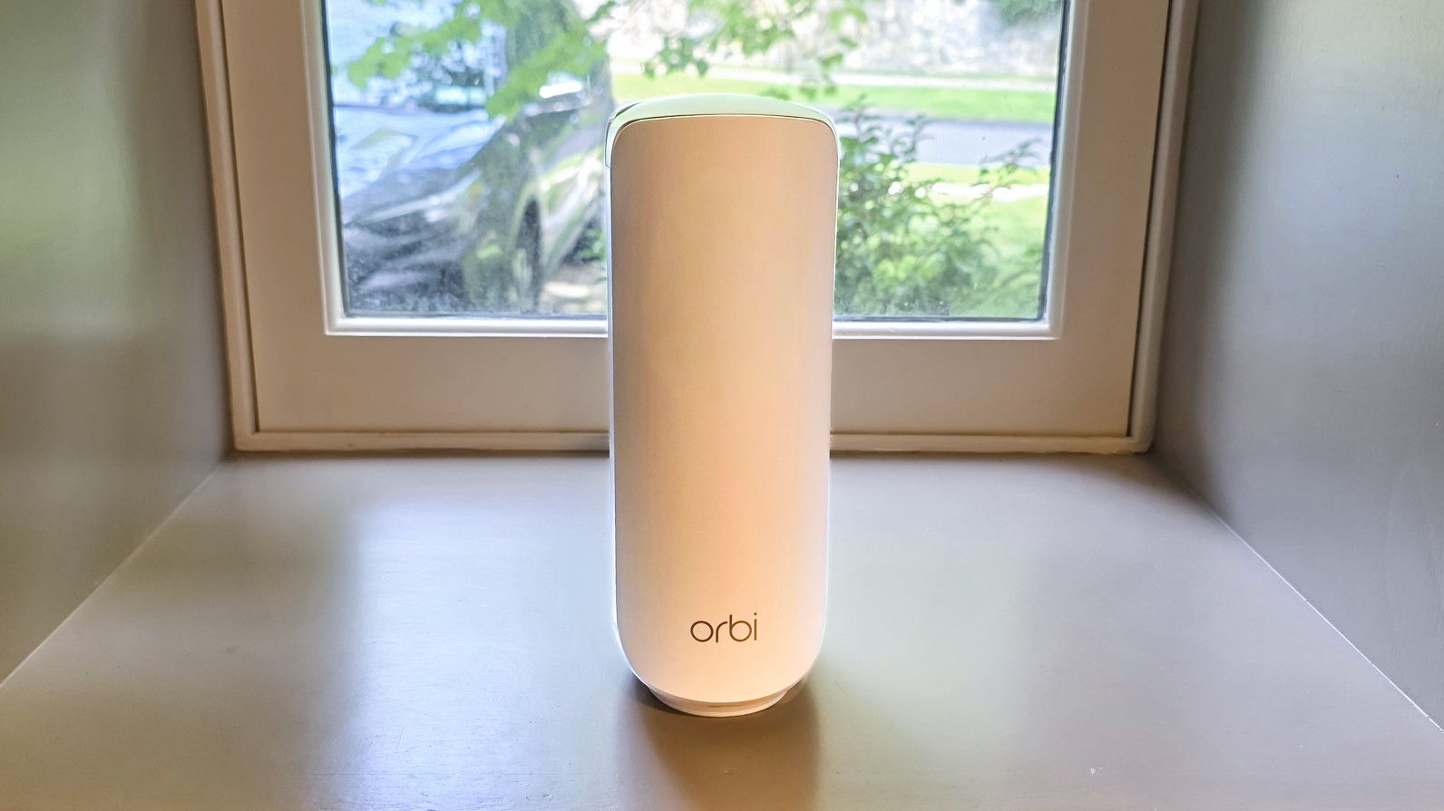The Netgear Orbi 370 mesh router on a window sill