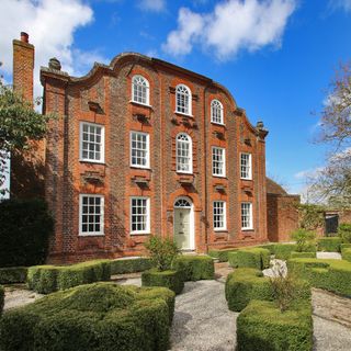 hall with brick wall exterior and garden