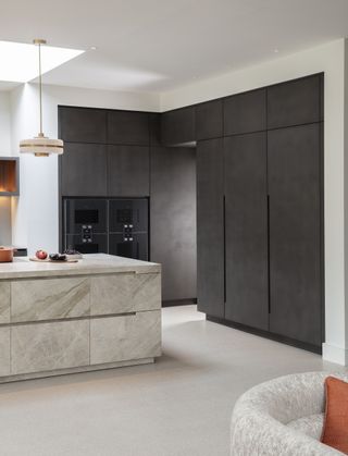 black corner units in modern kitchen with marble kitchen island,