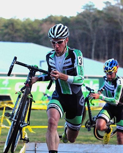 Jeremy Powers (Cannondale-Cyclocrossworld) leading Johnson over the barriers.