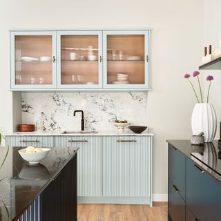 Blue reeded kitchen with glass reeded doors