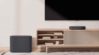 LG QP5 Eclair soundbar in a room with TV