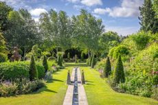 The West Garden at Alan Titchmarsh’s Hampshire home, showing the rill, topiary and, on the left, a towering terracotta Humphry Repton made by Jim Keeling of Whichford Pottery in Warwickshire. Photo: Jonathan Buckley