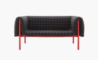 Padded sofa on red metal frame