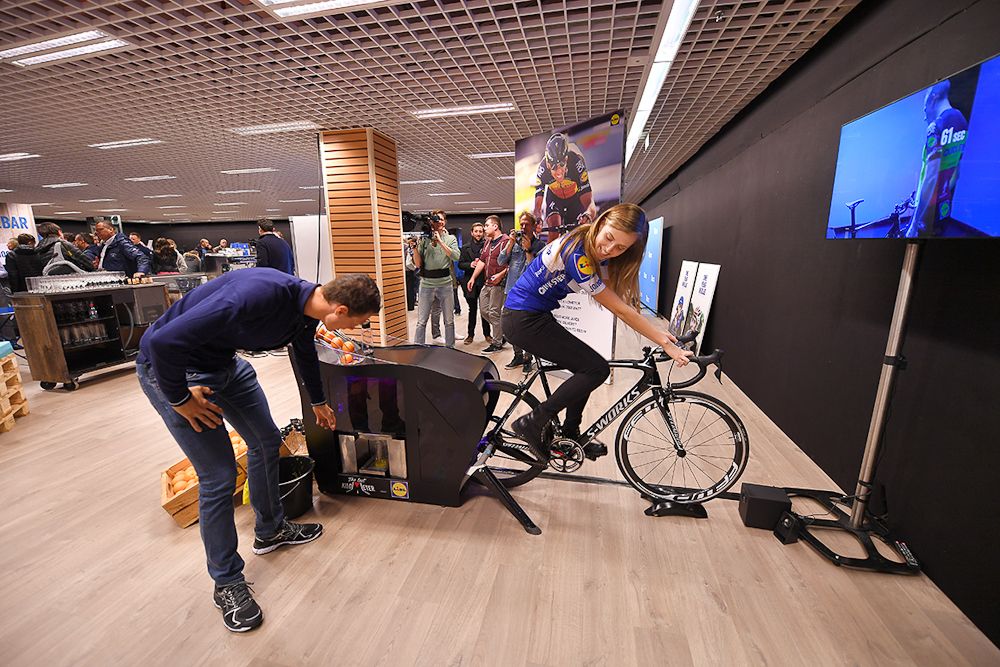 Niki Terpstra reaches for some freshly squeezed orange juice from this cycling-powered machine