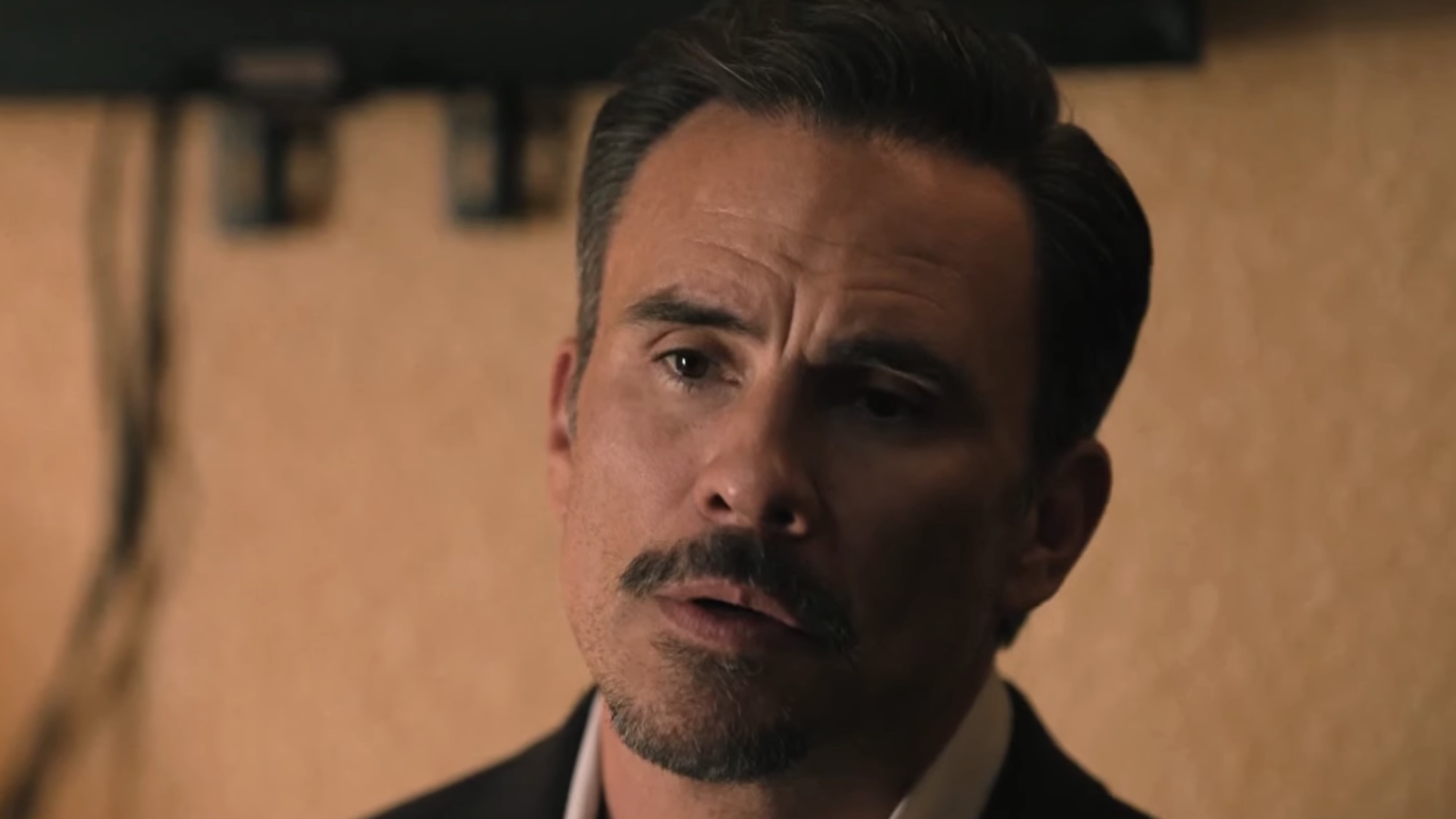 Joaquin sitting in hotel room talking to his father Mariano in Dutton Ranch Season 1 finale