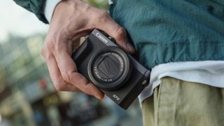 A photographer using the Canon PowerShot G7 X Mark III 30th Anniversary Edition in a street environment