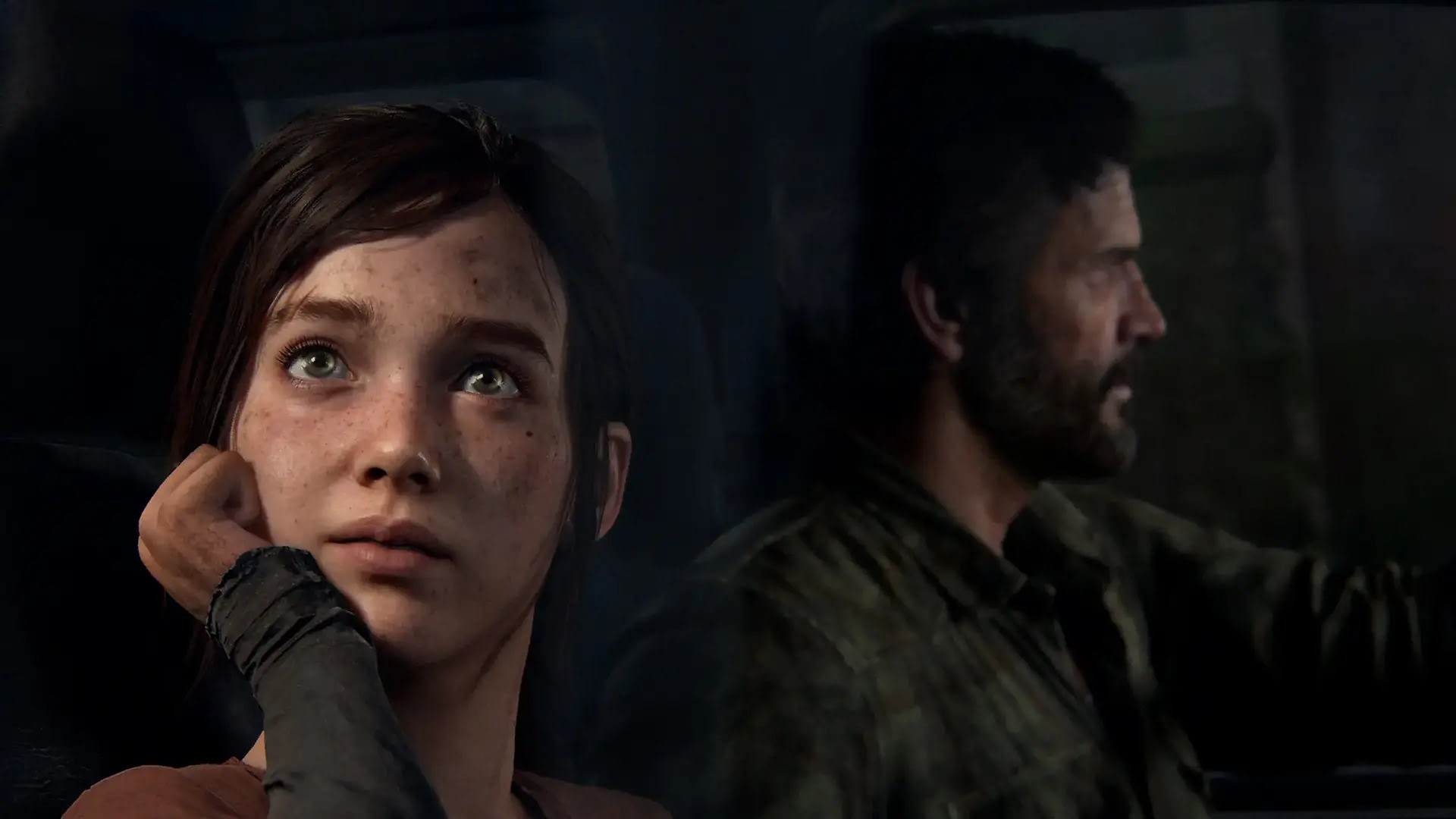Last of Us Part I, Ellie looking out of the window of a car while Joel drives in the background
