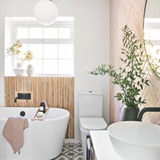 A clean white and pink tiled bathroom.