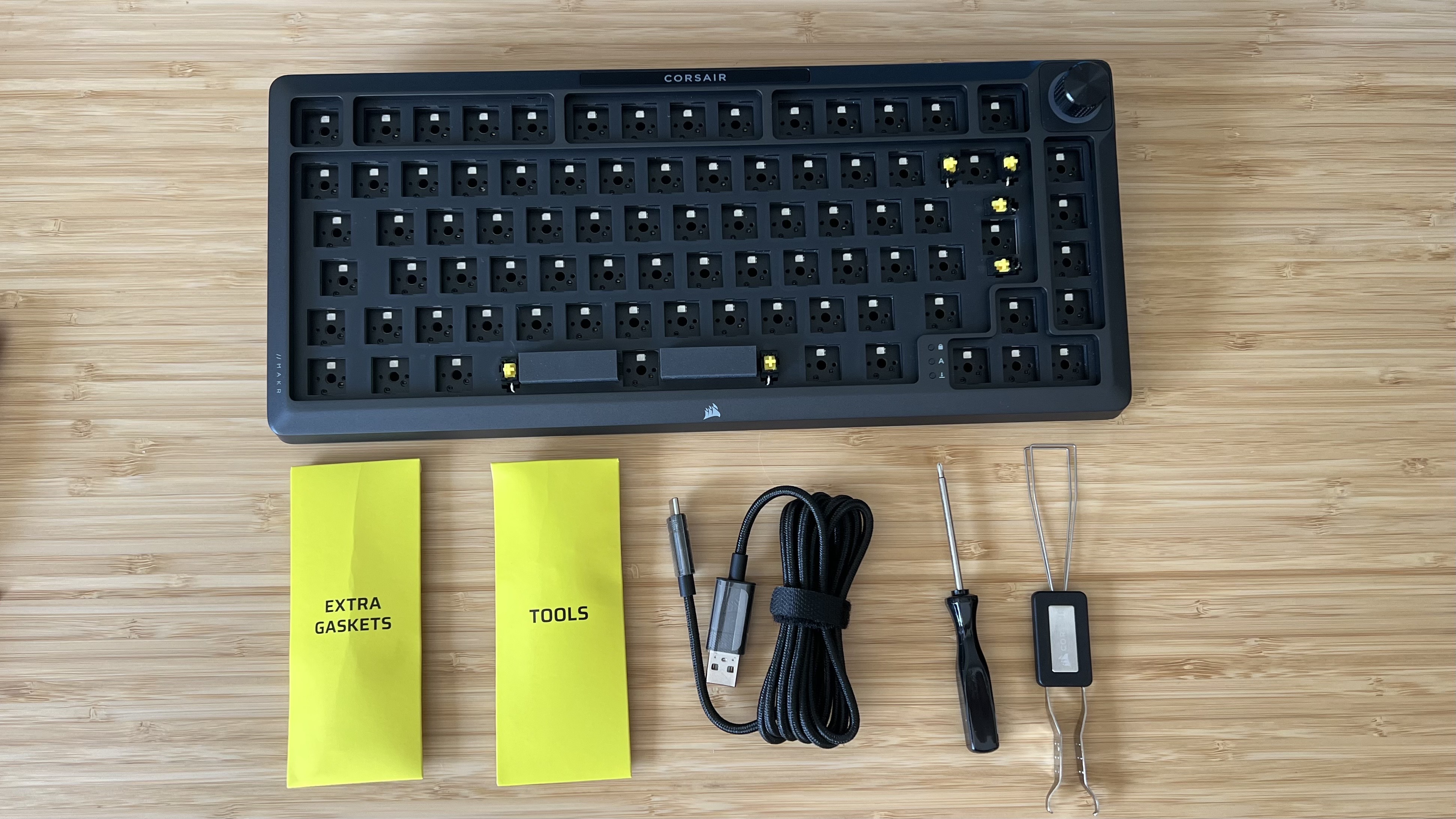 Corsair MAKR 75 barebone with accessories on a wooden desk