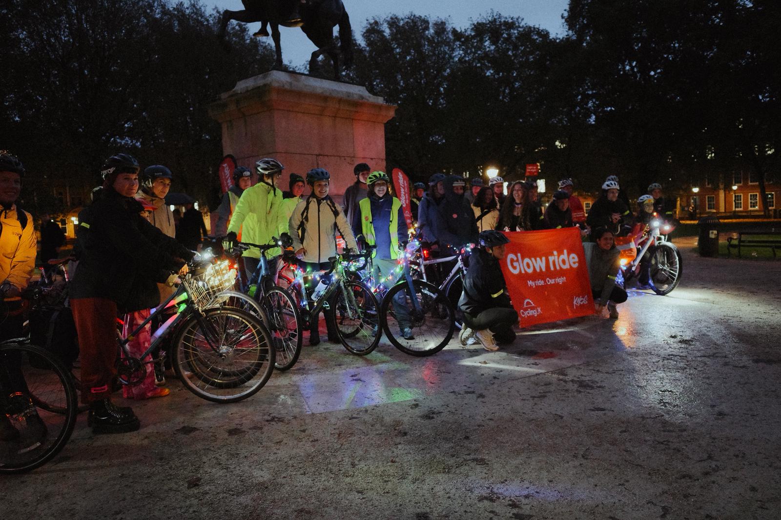 Women line up with bikes on a Glow Ride