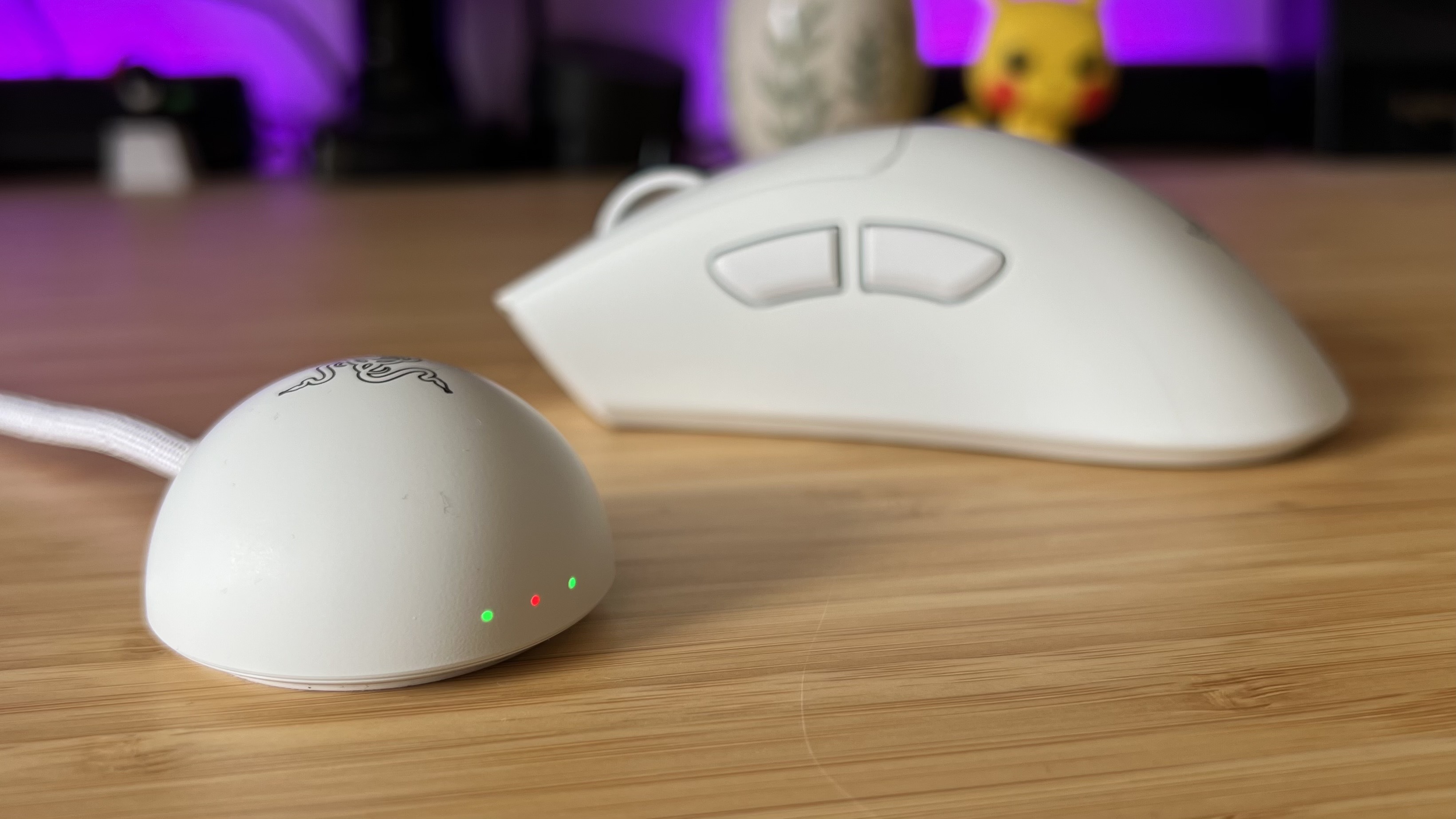 Razer 8,000Hz receiver with Deathadder V4 Pro gaming mouse in the background