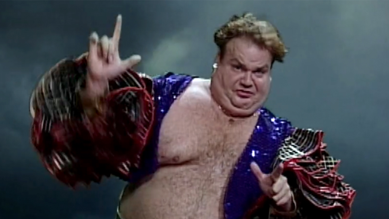 Chris Farley with no shirt and a sequin jacket making a funny face on Saturday Night Live