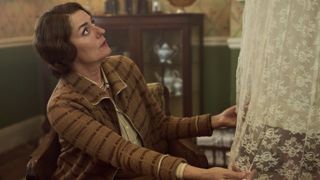 Anna Chancellor in a dark jacket as Muv adjusts a white dress in Outrageous.