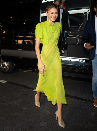 Zendaya wears a semi-sheer chartreuse gown in New York City with coordinating sandals