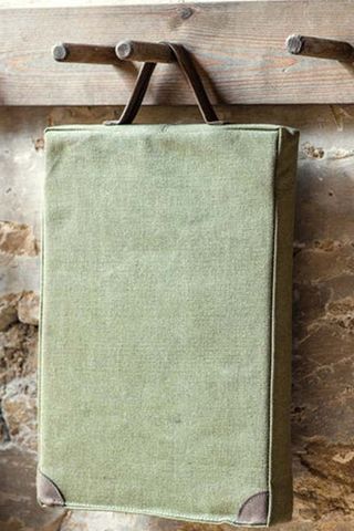 green garden kneeler hanging on a wall