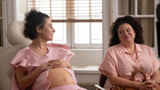 Ilana Glazer as pregnant Eden looking at Michelle Buteau's Dawn in Babes