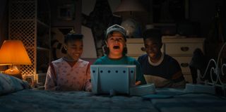Gaten Matarazzo as Dustin Henderson and Caleb McLaughlin as Lucas Sinclair are up to something spooky in an official image from Stranger Things season 4