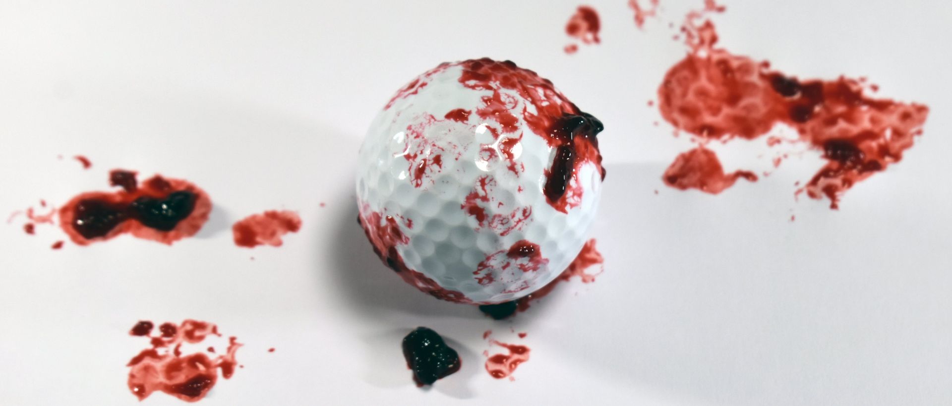 A golf ball covered in blood and guts, except actually it's fruit don't worry