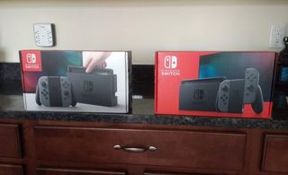 Old Switch packaging with white box next to new Switch packaging with red box 