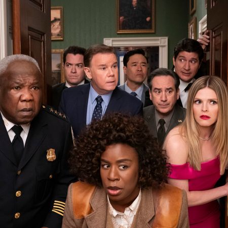 a group of people led by uzo aduba as detective cordelia cupp peek through a doorway in a still from the tv show the residence