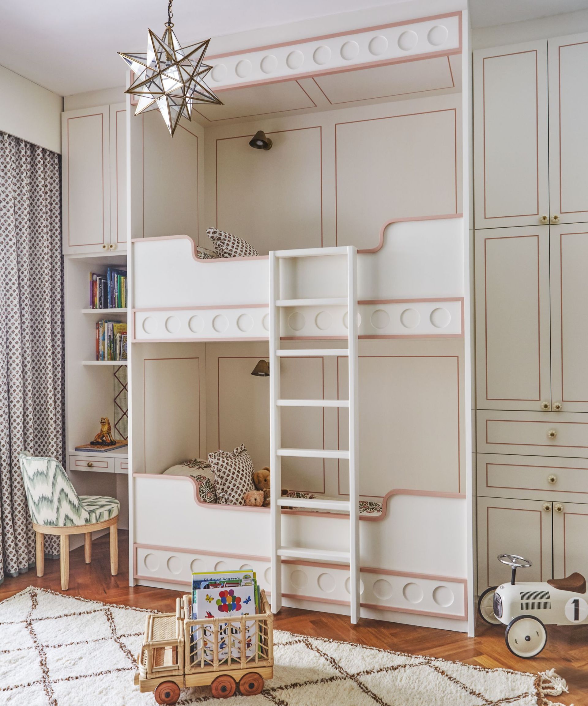 White bunkbed and cupboards, pink lining, white rug