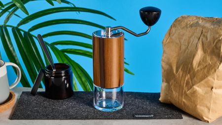 the comandante c40 mk4 hand coffee grinder with a glass catch chamber and high nitrogen steel burrs