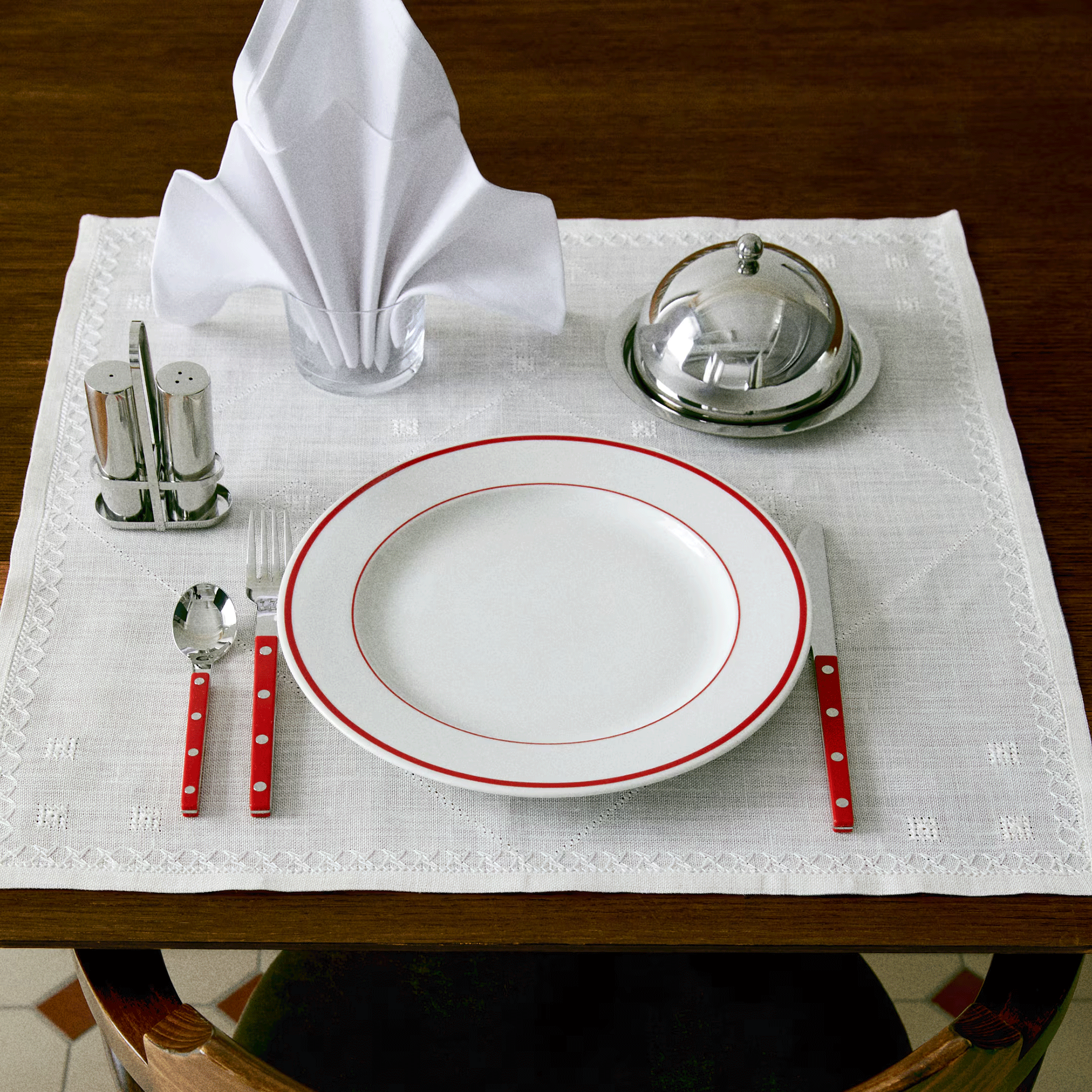 Butter dish on wooden table with white table cloth