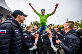 Slovenia's Tadej Pogacar celebrates with his team after winning the men's Elite Road Race cycling event during the UCI 2024 Road World Championships, in Zurich, on September 29, 2024. (Photo by Fabrice COFFRINI / AFP)