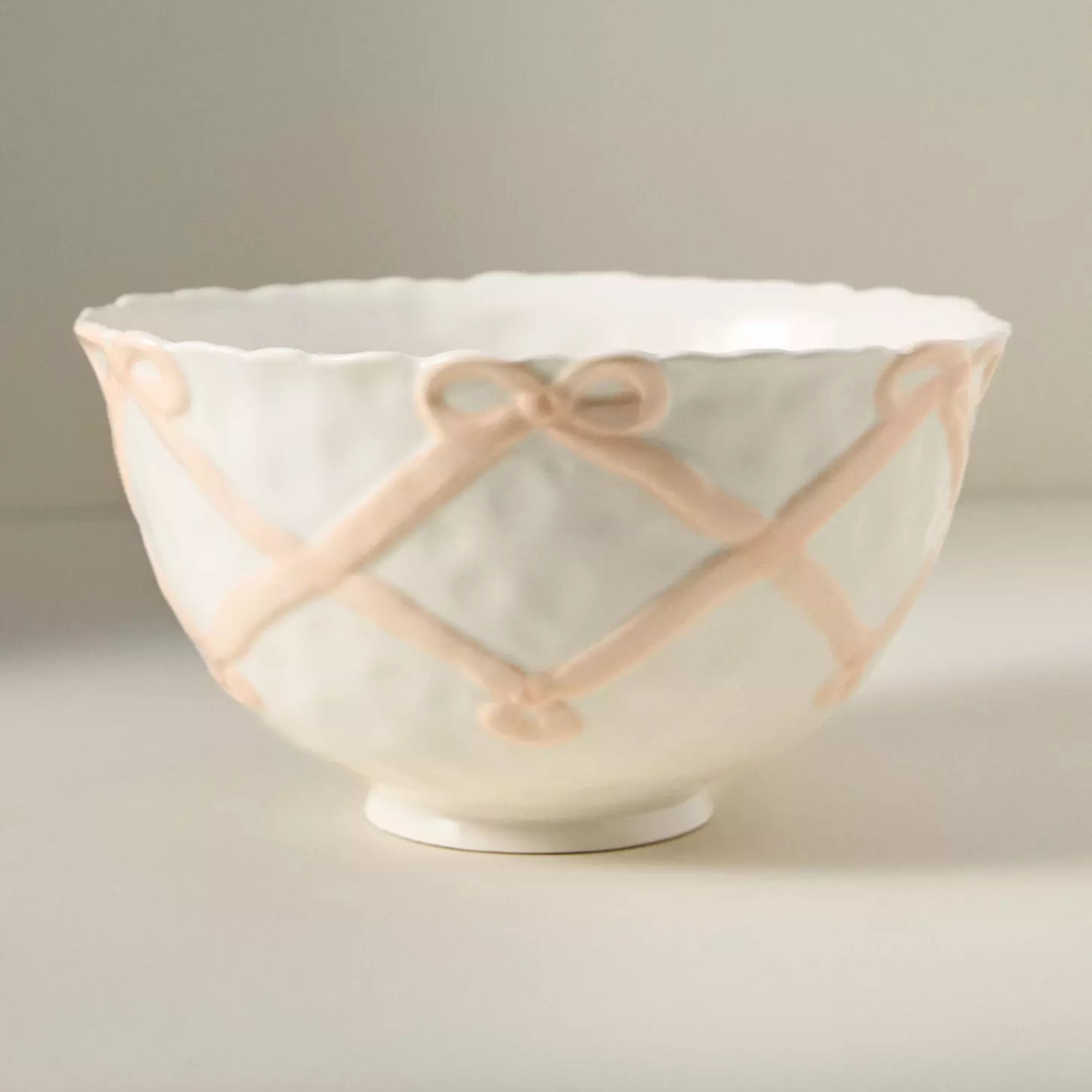 White bowl with pink embossed bow design