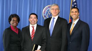 Former FCC Chairman Tom Wheeler, second from right, stands next to new FCC Chairman Ajit Pai, far right