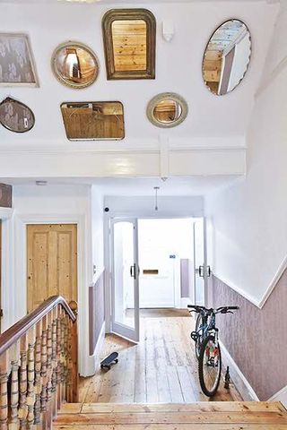Apartment renovation staircase with mirrors above