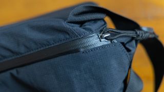 A closeup of the weather-sealed zipper on the Bellroy Venture 10L Sling Camera Edition bag